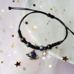 bracelet fantaisie planete avec anneau dore et perles colorees corde noire et planete bleu 257 1